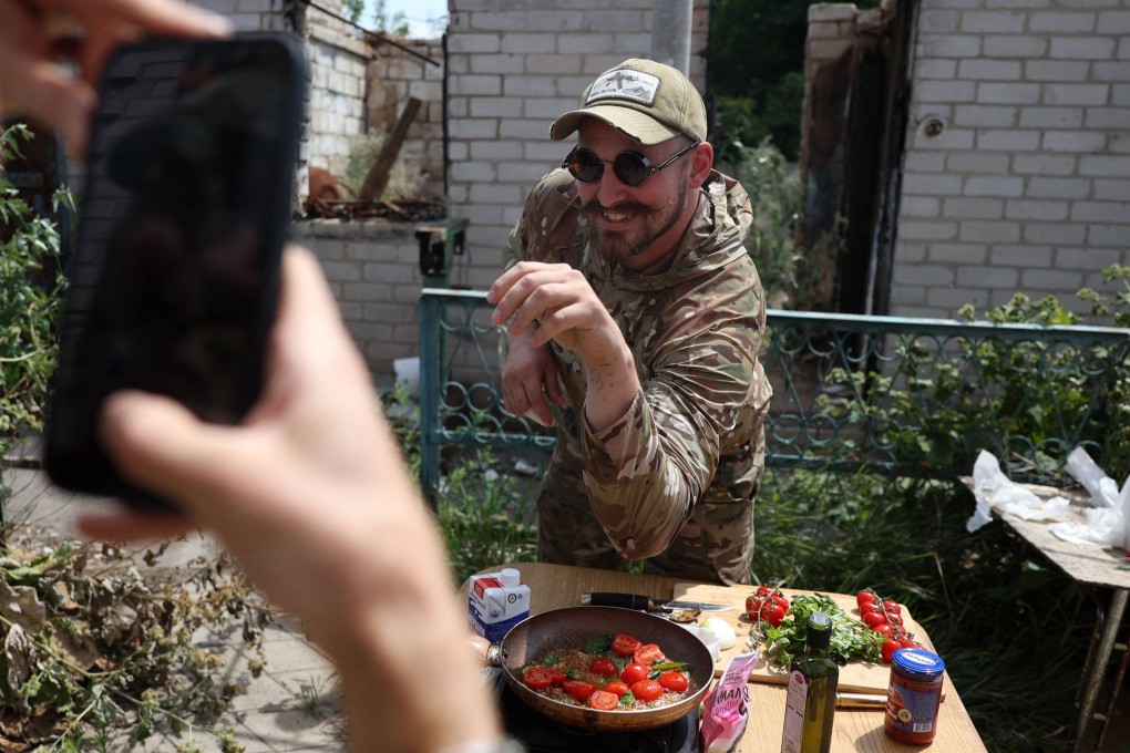 Ruslan Mokrytskyi poses for a TikTok recipe video while cooking pasta all’Arrabbiata. What sets him apart from other chef influencers is that he is a soldier on the front line of Ukraine’s war with Russia. Photo: AFP