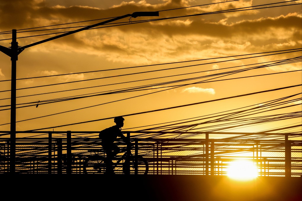 A man rides his bicycle under the scorching heat of the sun amid El Nino in Quezon City, the Philippines, on April 30. Climate change is just one of the problems facing the world that AI can be deployed to help tackle. Photo: Xinhua
