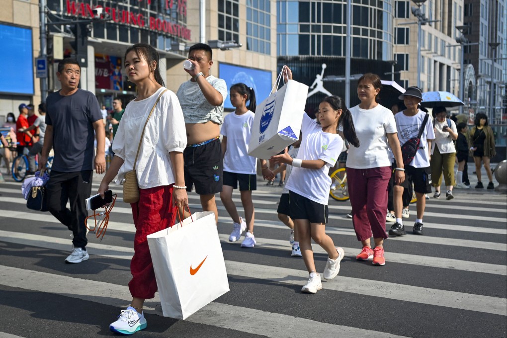 Shoppers in Beijing. Our “stuff-obsessed” lifestyles are simply unsustainable. Photo: AFP