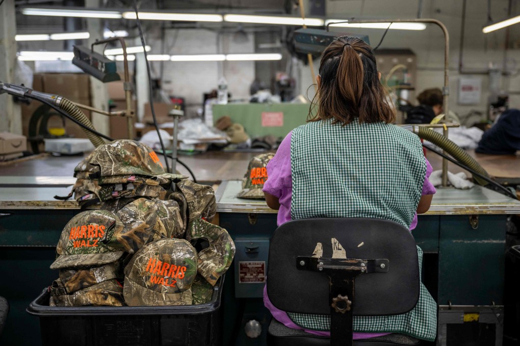 An employee works on embroidered campaign hats for US Democratic presidential candidate Kamala Harris and vice-presidential candidate Tim Walz at Unionwear in Newark, New Jersey. Photo: AFP