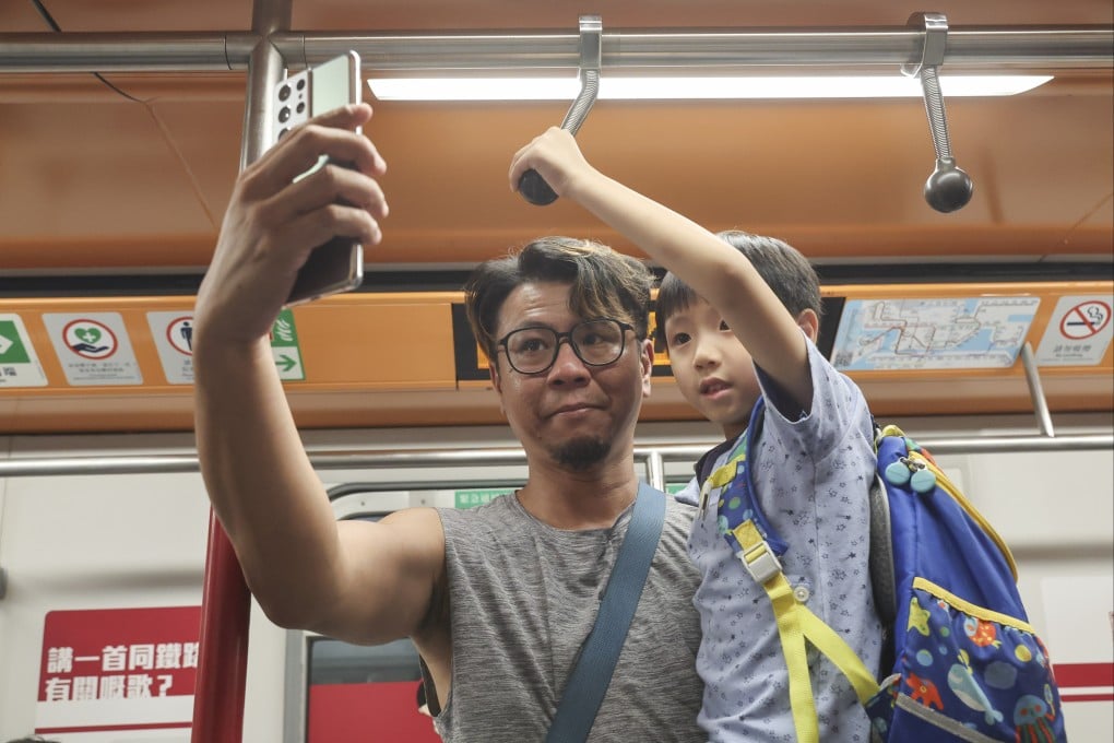A father introduces his son to old-style hand straps in one of the carriages. Photo: Edmond So