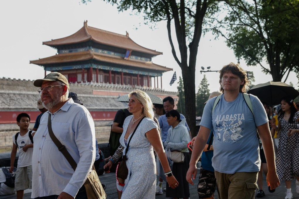 Foreign tourists walk near the Forbidden City in Beijing on August 13. According to the National Immigration Administration, the country recorded about 14.6 million entries by foreign tourists in the first half of 2024, an increase of more than 150 per cent year on year. Photo: EPA-EFE