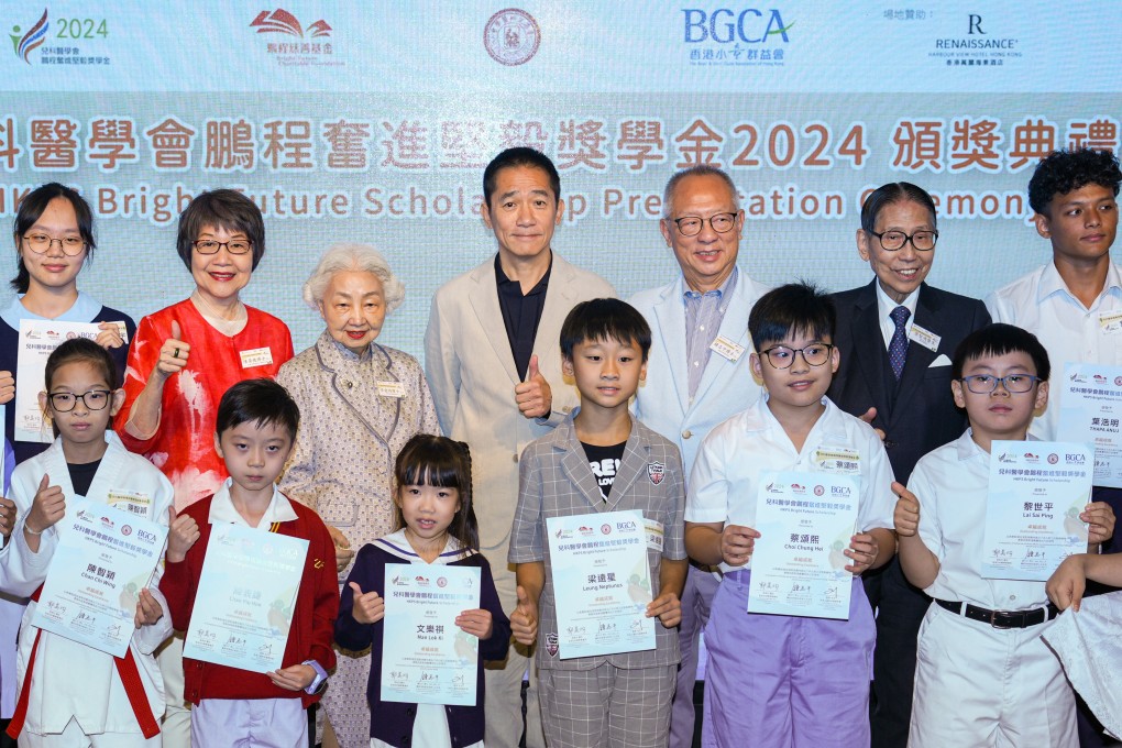 Actor Tony Leung and other scholarship patrons pose for photos with awardees of the Pediatric Society Bright Future Scholarship. Photo: Eugene Lee