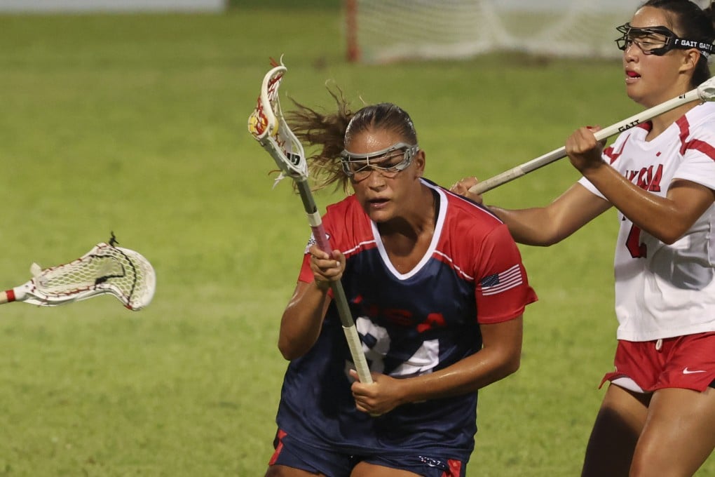 Kori Edmondson (centre) of the USA powers past several Canada players in the final of the World Lacrosse Women’s U20 Championship at Mong Kok Stadium. Photo: Dickson Lee