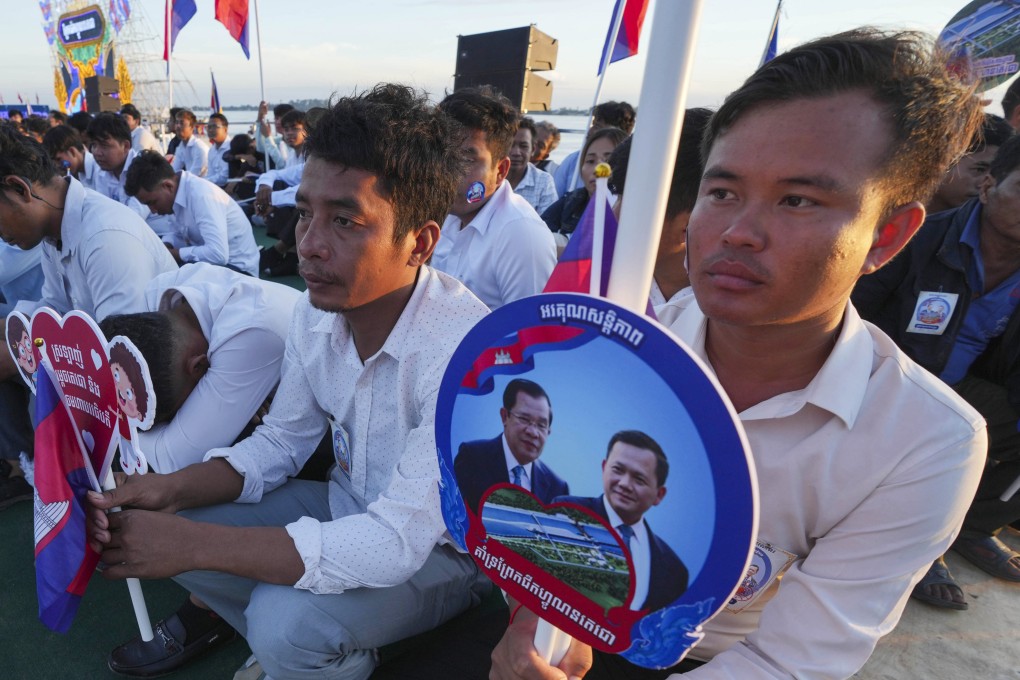 Cambodians hold photographs of their Prime Minister Hun Manet and his father Hun Sen at a groundbreaking ceremony of the China-funded Funan Techo canal. Photo: AP