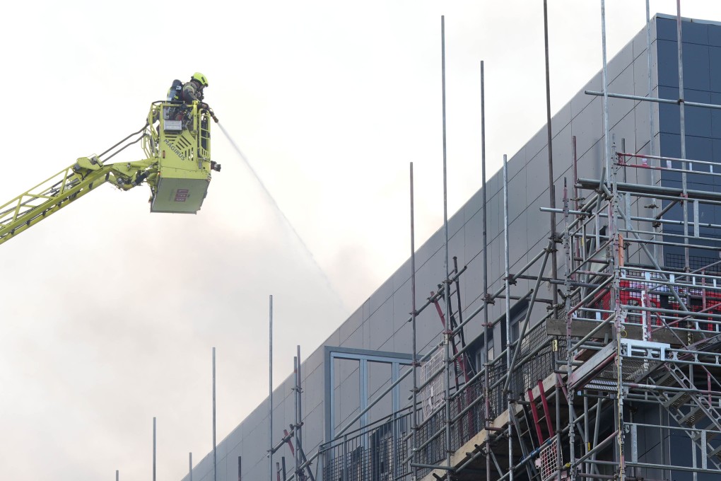 Firefighters at the scene after a blaze at a block of flats on Freshwater Road in Dagenham. More than 100 people were evacuated from the building. Photo: dpa