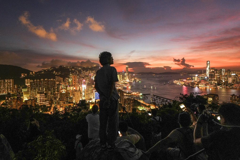 Residents and tourists enjoy the sunset at Red Incense Burner Summit in North Point on July 23. Photo: Eugene Lee