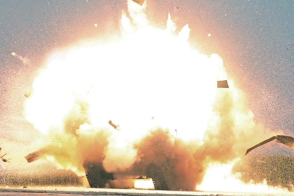 A mock tank explodes during a “suicide drone” performance test at the Drone Institute of North Korea’s Academy of Defence Sciences. Photo: KCNA/via EPA-EFE