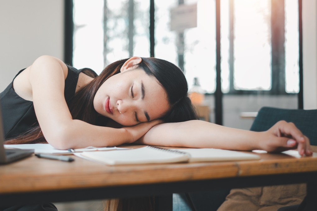 A woman takes a short afternoon nap between working. Experts say 15-20 minutes is perfect for letting your mind and body recuperate, and that longer naps can result in grogginess. Photo: Shutterstock
