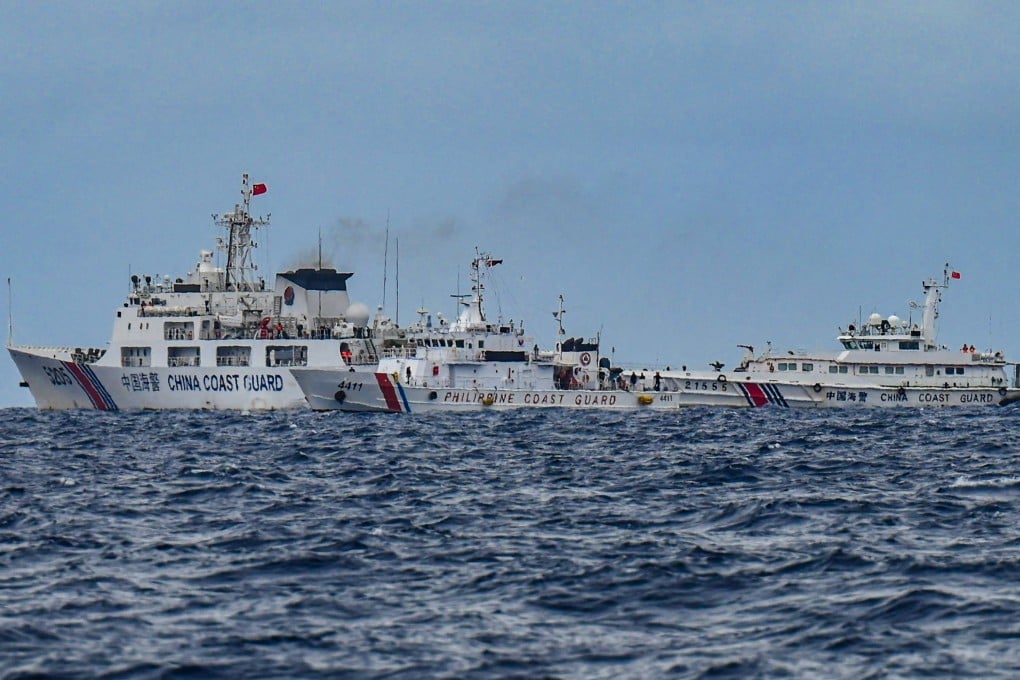 Chinese coastguard vessels sail near a Philippine Coast Guard ship said to be on a supply mission to Sabina Shoal, in disputed waters of the South China Sea on Monday. Photo: AFP