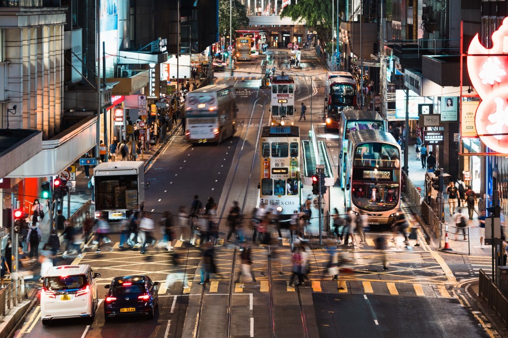 Pedestrians cross a road in Central in June 2023. Running Hong Kong through trickle-down mainland pronouncements  - however well-meaning – runs the risk of pushing the city further into the shadows. Photo: Shutterstock