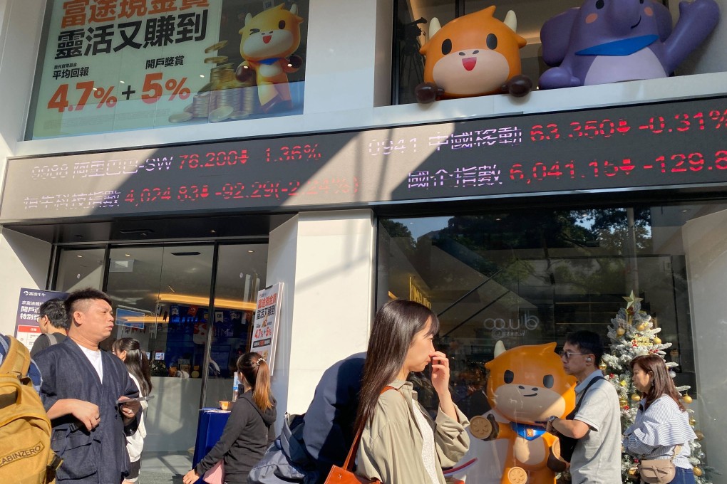 People walking outside a building with running stock tickers in Tsim Sha Tsui, Hong Kong in November 2023. Photo: Li Jiaxing