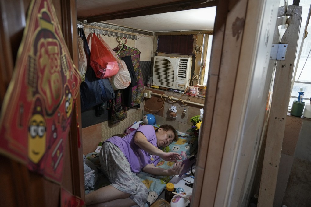 A resident is seen in a subdivided flat in Mong Kok in July. Photo: Sam Tsang