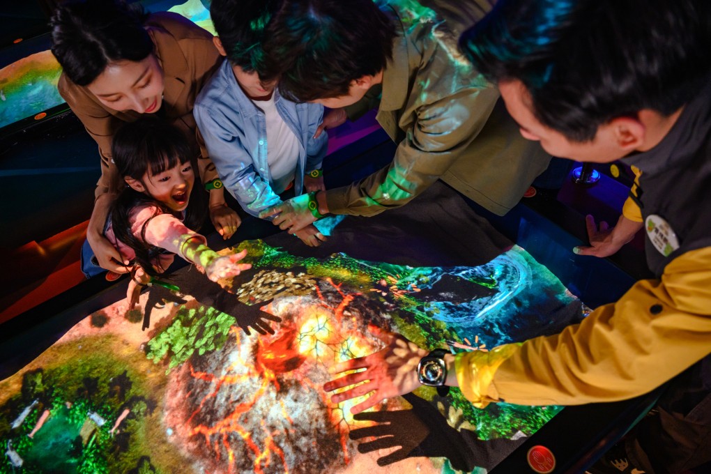 People enjoy an interactive feature at the National Geographic Ultimate Explorer “edutainment park” in Novotown, Hengqin, Zhuhai. The Greater Bay Area city offers plenty for visitors, including theme parks, night markets and a cableway. Photo: Novotown
