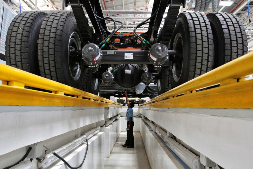An employee inspects the engine of a truck inside a factory in Oragadam in the Kancheepuram district of the southern Indian state of Tamil Nadu. Photo: Reuters