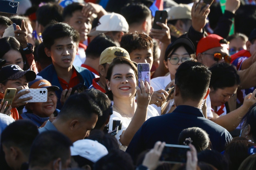 Vice-president Sara Duterte (middle) takes a selfie with her supporters during a rally in Manila. Photo: EPA-EFE