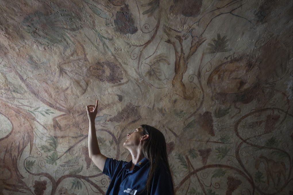 A worker points to an ancient wall of the archeological tomb site in Ashkelon, Israel on Tuesday. Photo: AP