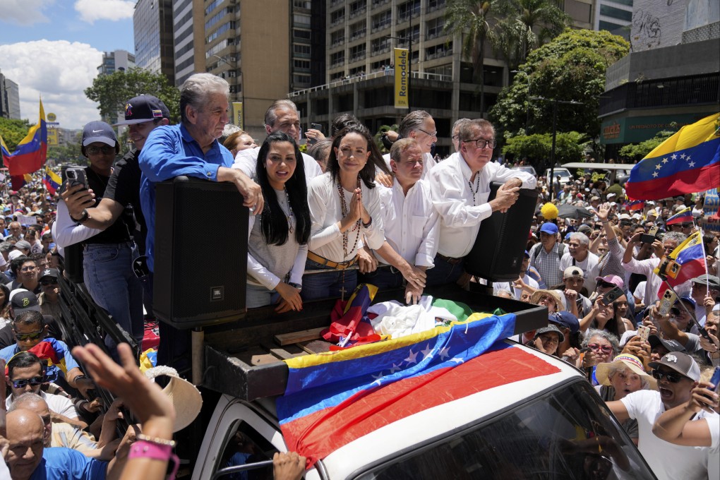 Maria Corina Machado, centre, leads a protest against the re-election of President Nicolas Maduro in Caracas, Venezuela. Photo: AP