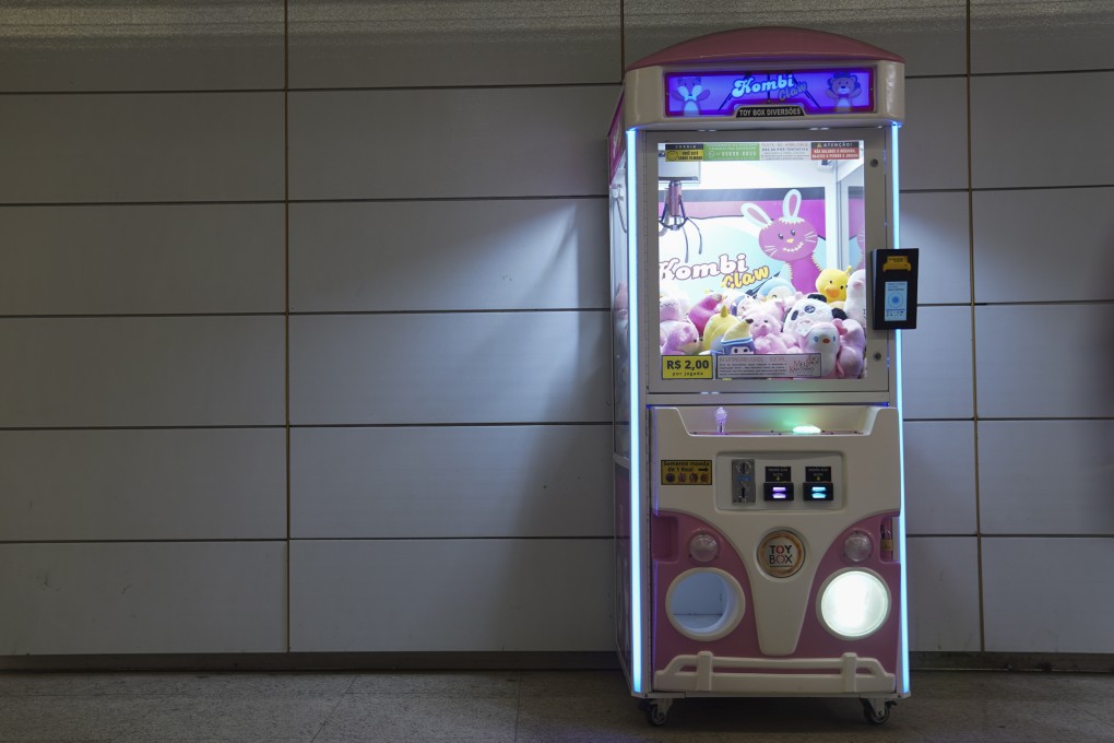 A claw machine sits inside a metro station in Rio de Janeiro. Police in the city have started seizing the popular claw machines, which they say are games of chance, and are investigating links to organised crime. Photo: AP