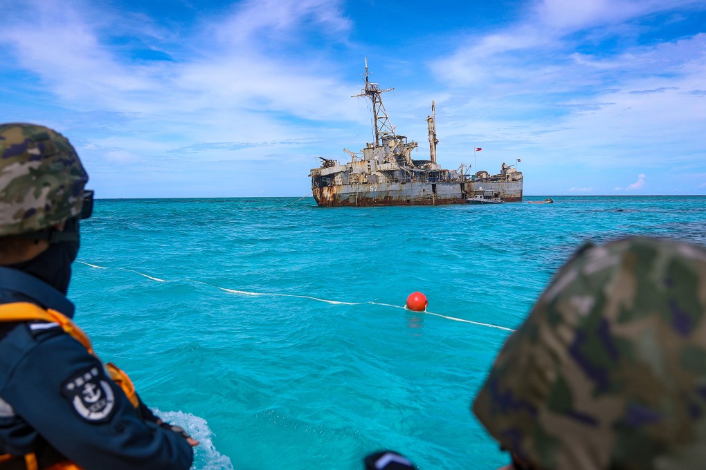 Chinese personnel look at the BRP Sierra Madre, a dilapidated World War II-era Philippine navy vessel grounded at Second Thomas Shoal in the South China Sea. Photo: China Coast Guard/Handout via Xinhua