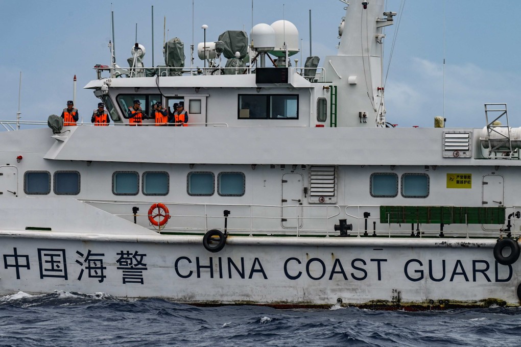Personnel on board a China Coast Guard ship are seen from the Philippine Coast Guard vessel BRP Cabra during a supply mission to Sabina Shoal in disputed waters of the South China Sea on August 26, 2024. Photo: AFP