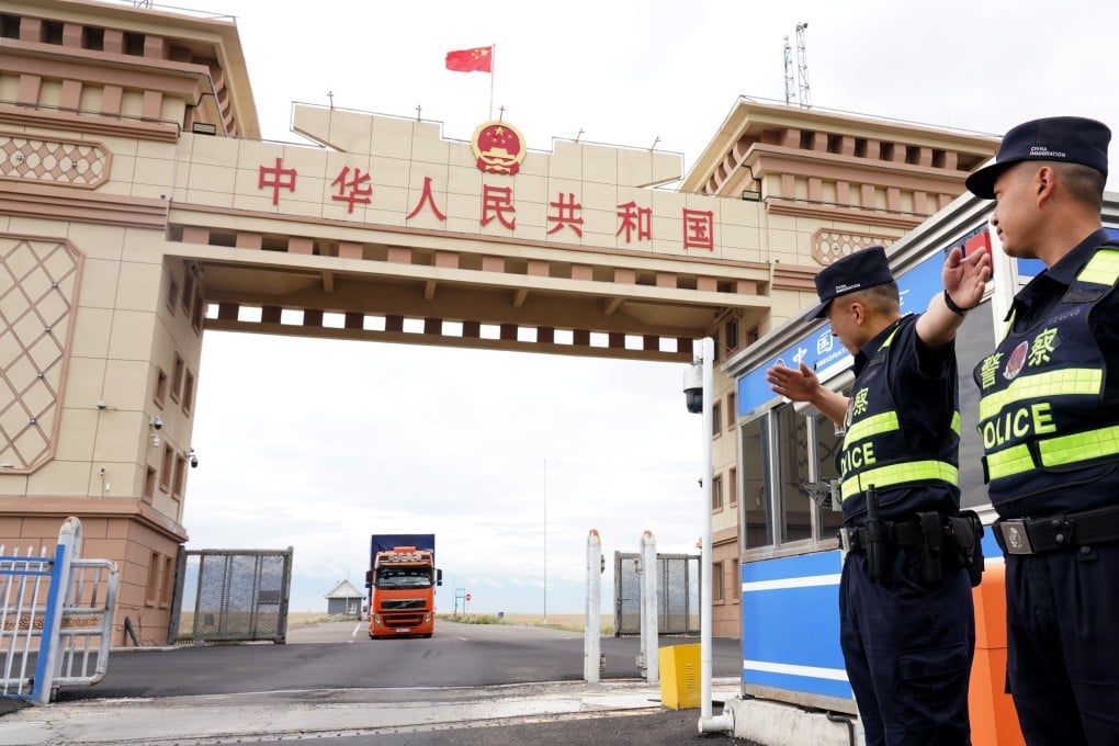 Chinese police officers guide vehicles across the border from Kazakhstan in the Xinjiang Uygur autonomous region in July. Photo: Xinhua