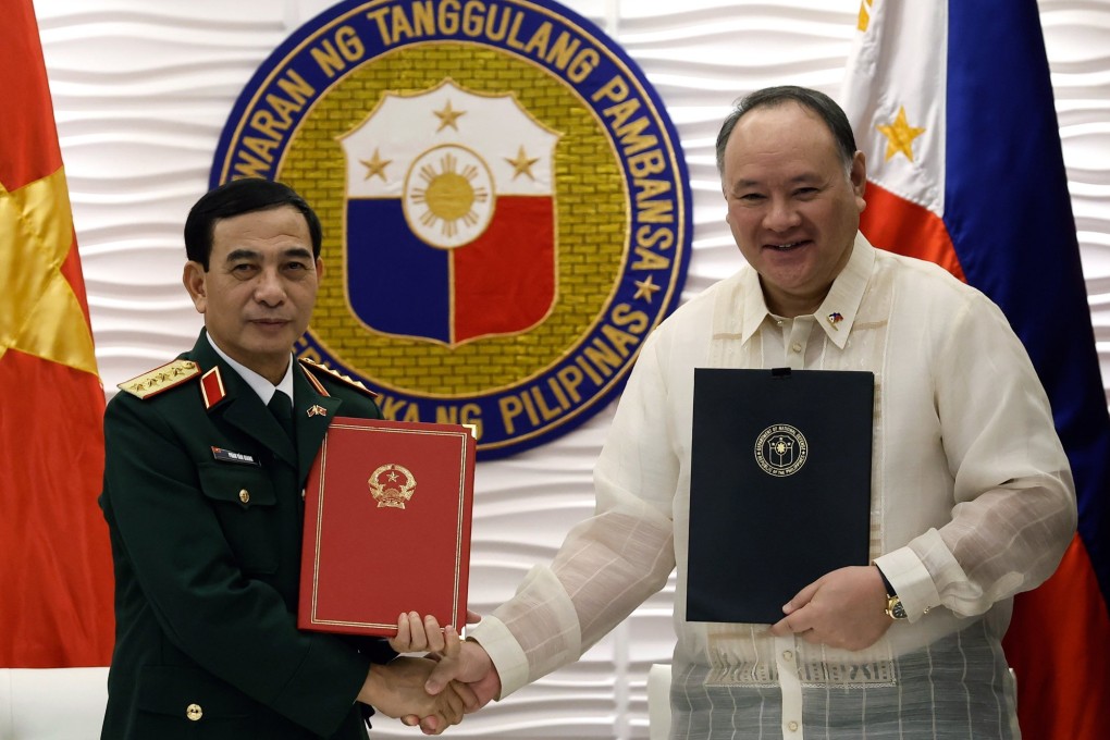 Vietnam’s Defence Minister Phan Van Giang (left) and his Philippine counterpart Gilberto Teodoro hold documents they signed after a bilateral meeting at the Department of National Defence in Quezon City, Metro Manila, the Philippines, on Friday. Photo: EPA-EFE