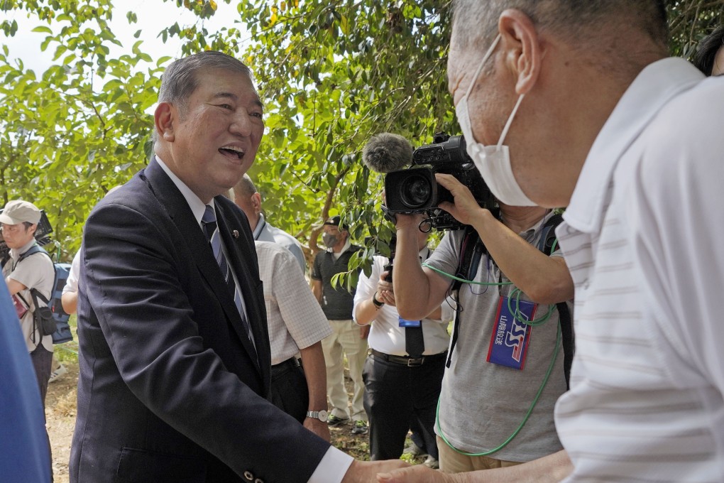 Former Japanese defence minister Shigeru Ishiba shakes hands with a supporter in Yazu, Tottori Prefecture, on August 24. He has announced his candidacy in the ruling party’s leadership race in September. Photo: Kyodo