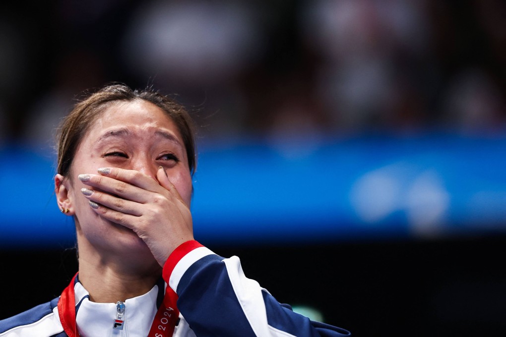 Hong Kong’s Chan Yui-lam is overcome with emotion standing on the podium after winning silver in the women’s S14 100m butterfly at the Paris Paralympics. Photo: AFP