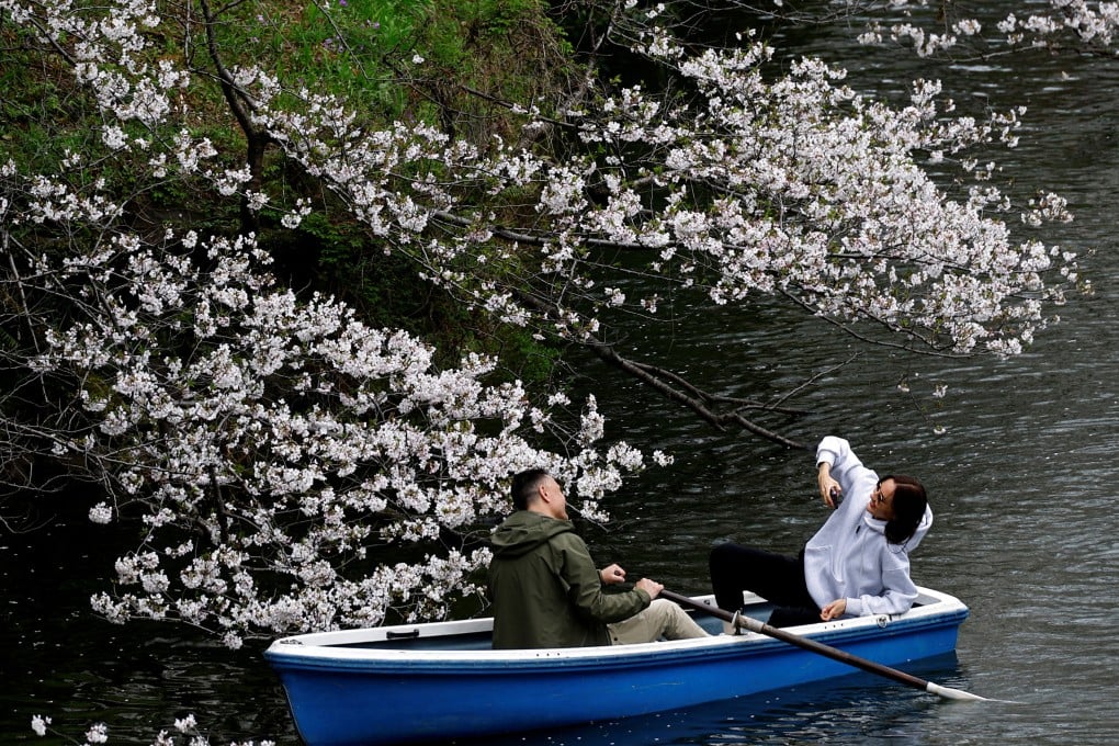 Tourists ride a boat at Chidorigafuchi Park in Tokyo. Photo: Reuters