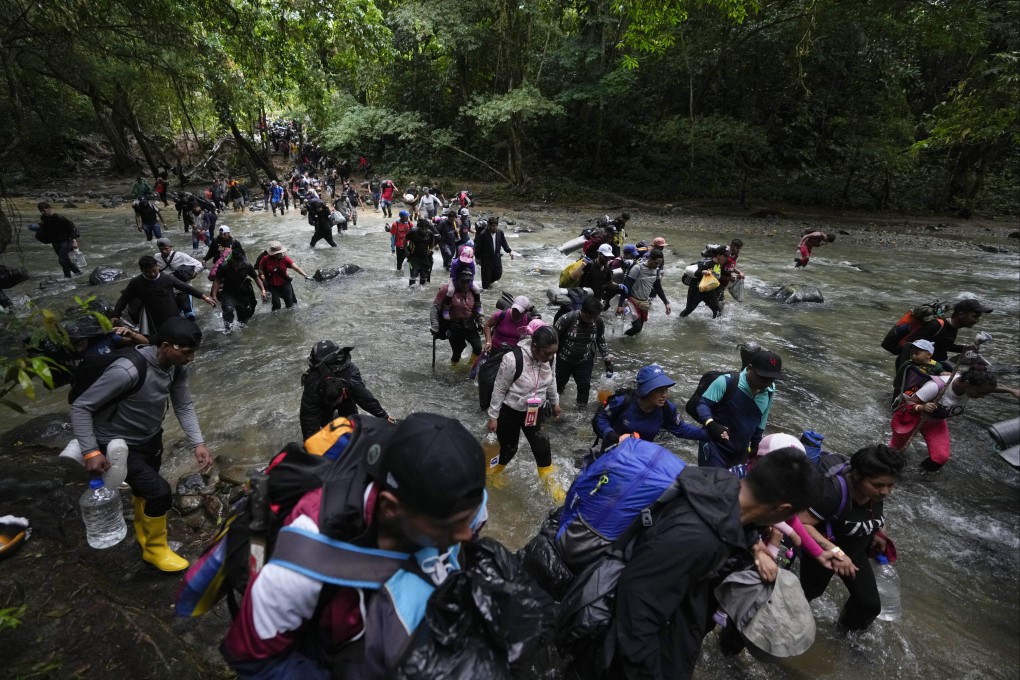 Migrants cross a river during their journey through the Darien Gap from Colombia into Panama, hoping to reach the US, on Octover 15, 2022. Photo: AP