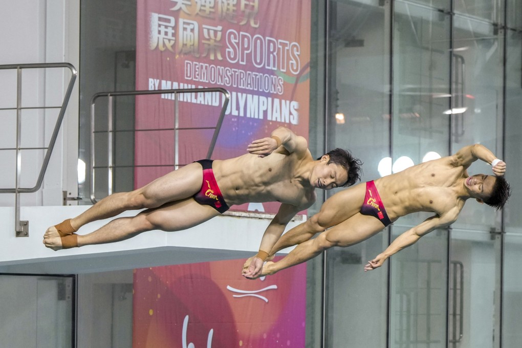 Divers Wang Zongyuan (left) and Long Daoyi showcase their skills at a public event in Hong Kong on Saturday. Photo: Sam Tsang