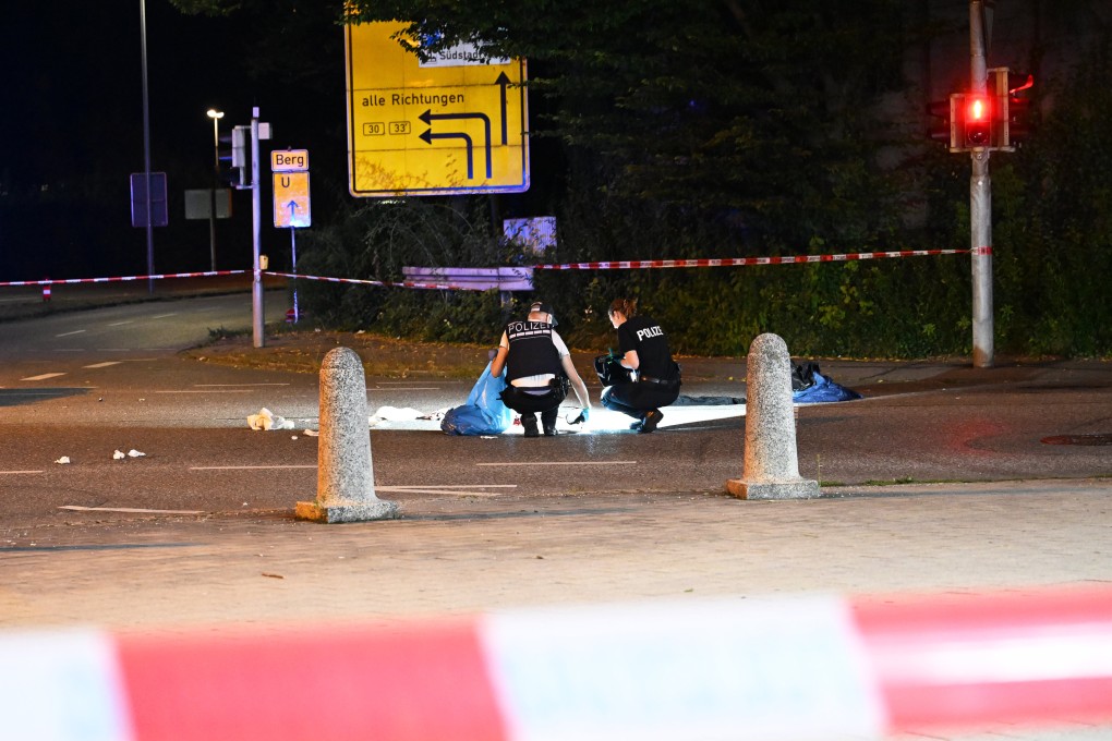 Police officers investigate on Friday after a knife attack on a bus in the German city of Siegen. Photo: dpa