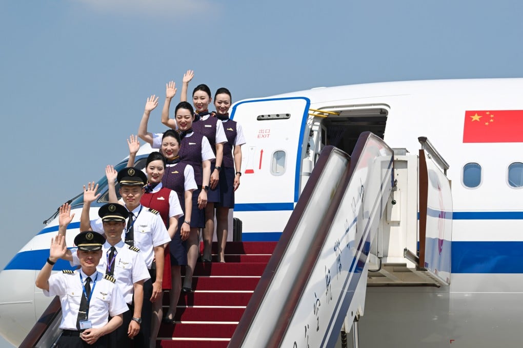 Air China crew pose with the airline’s first C919 jet on Thursday, shortly after its arrival at Beijing Capital International Airport. Photo: Xinhua