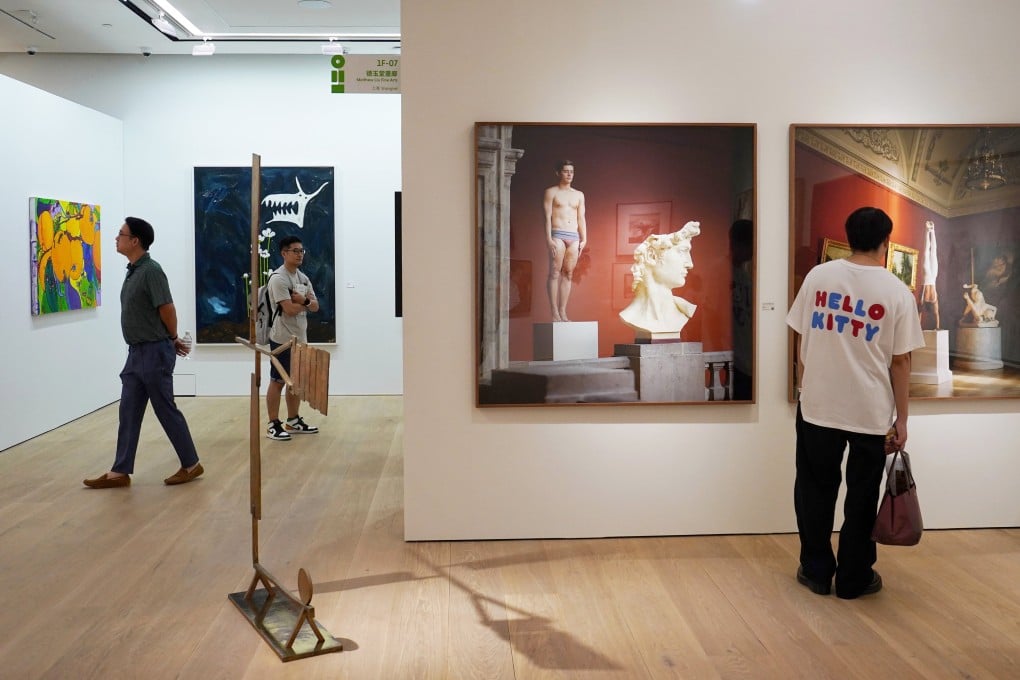 Viewers take a close look at artworks on display as part of the Art021 fair at the Philips Asia headquarters. Photo: Elson Li