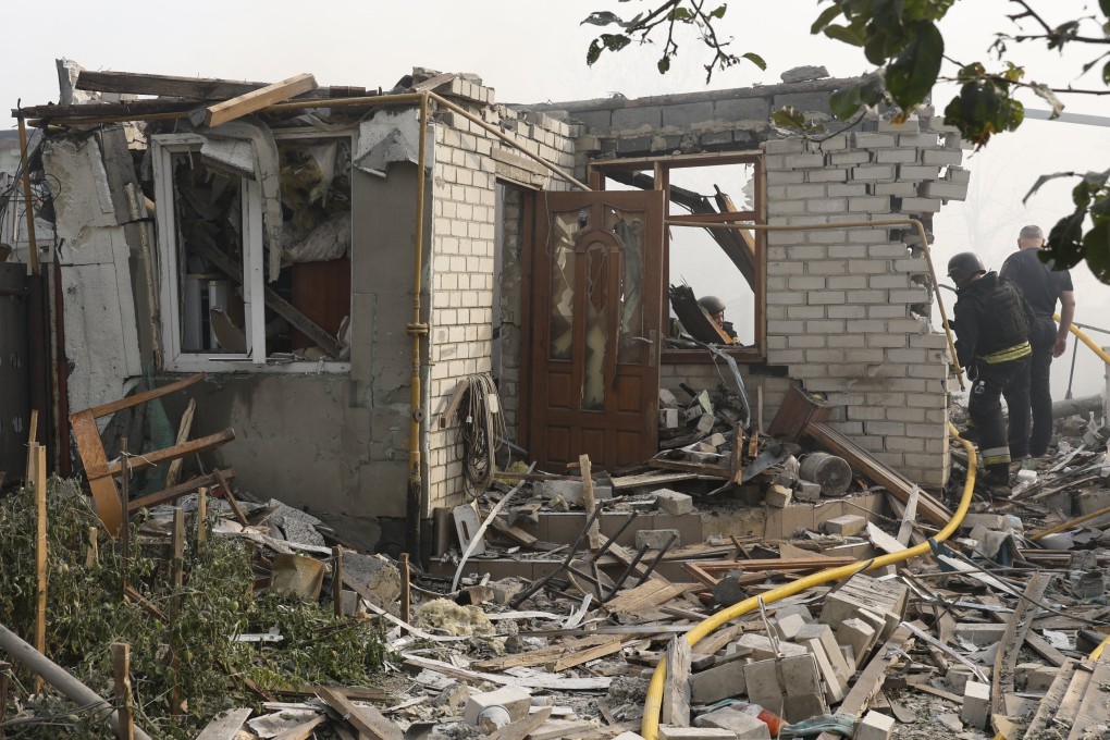 Ukrainian rescuers work at the site of a missile strike in Cherkaska Lozova, Kharkiv region, on Saturday. Photo: EPA-EFE