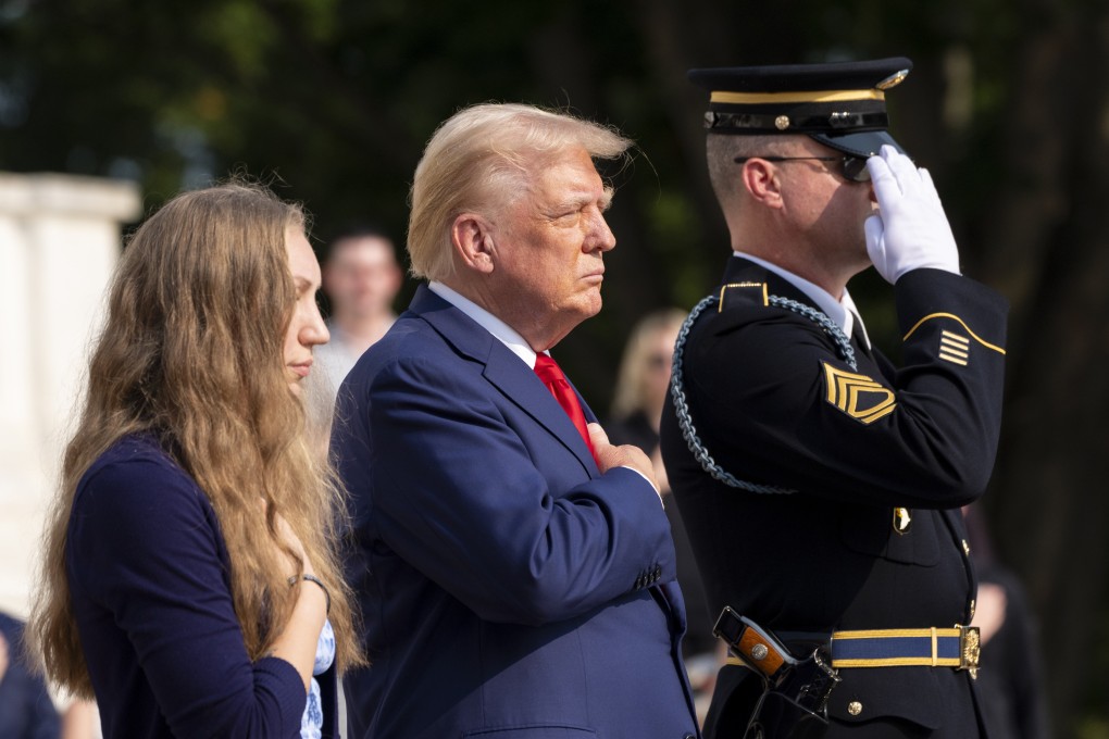 Republican US presidential nominee Donald Trump places his hands over his heart after placing a wreath in honour of Sergeant. Nicole Gee at the Tomb of the Unknown Solider at Arlington National Cemetery in Virginia on Monday. Photo: AP