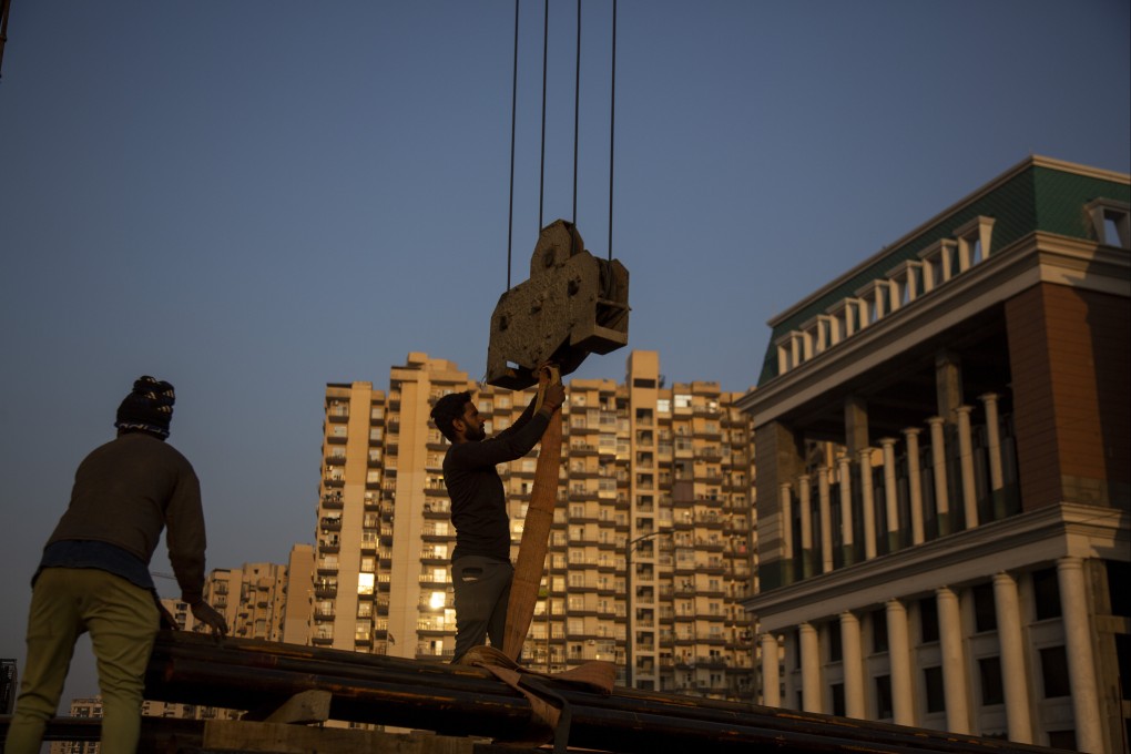 Workers handle building construction material in Greater Noida, Uttar Pradesh, India, on December 7, 2022. India’s property industry is well placed to continue benefiting from resilient growth. Photo: AP