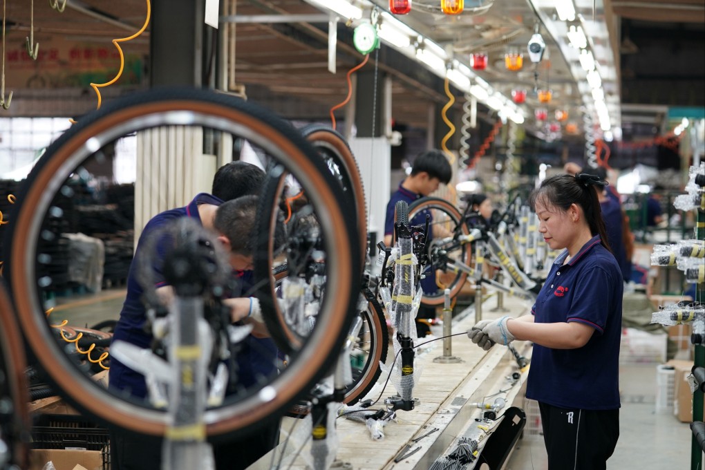Workers assemble parts at a children wheels factory in Pingxiang County in northern China’s Hebei province. Photo: Xinhua