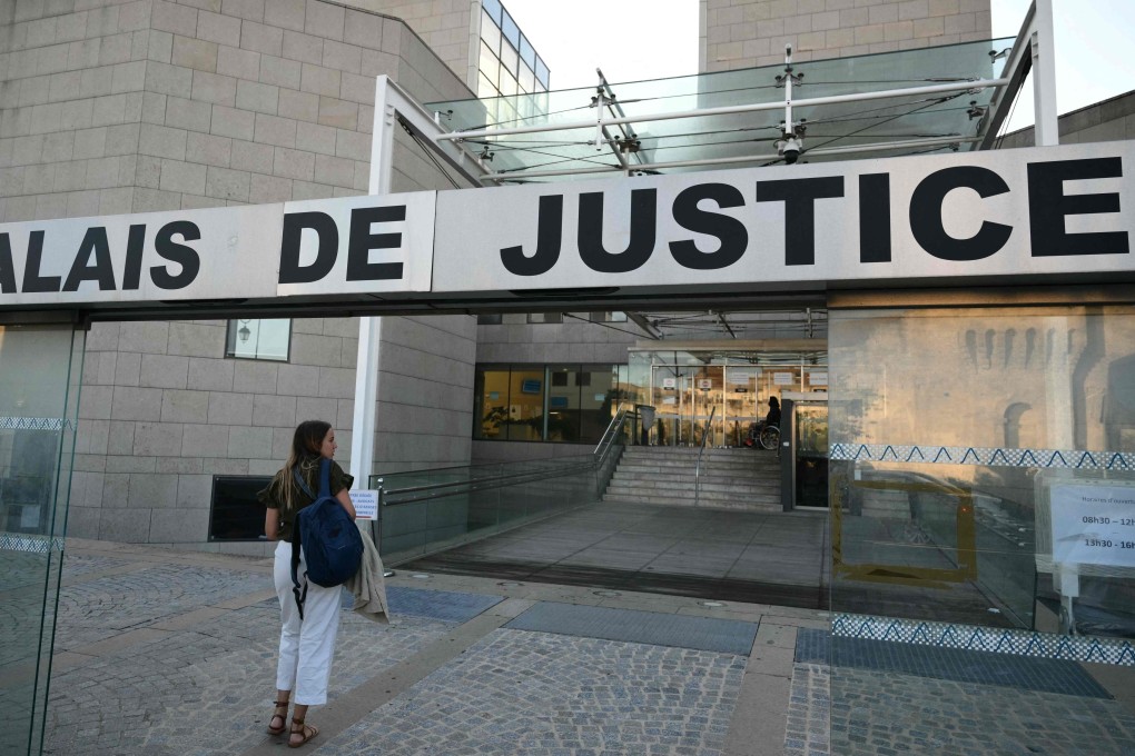 A wonan arrives at the courthouse before the trial of a man accused of drugging his wife for nearly ten years and inviting strangers to rape her at their home in the south of France. Photo: AFP