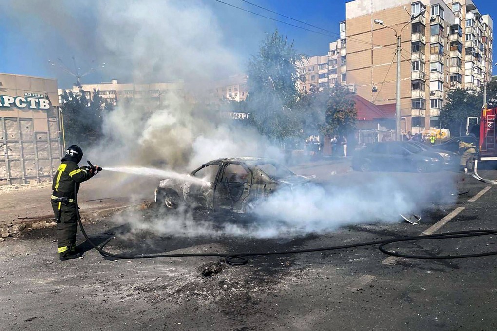 A firefighter extinguishes a car blaze after a recent shelling by a Ukrainian strike in Belgorod, Russia. Photo: Handout / Telegram / vvgladkov / AFP