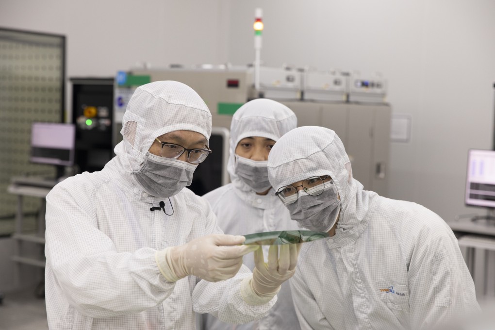 Workers inspect a semiconductor wafer at the headquarters of TankeBlue Semiconductor Company in Beijing on January 24. Photo: Xinhua