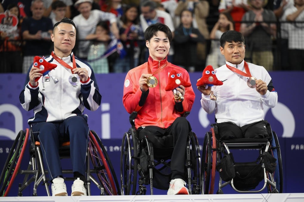 Silver medallist Chan Ho-yuen of Hong Kong, gold medallist Daiki Kajiwara of Japan and bronze medallist Kim Jung-jun of South Korea on the podium after the wheelchair badminton WH2 singles on Monday. Photo: Kyodo