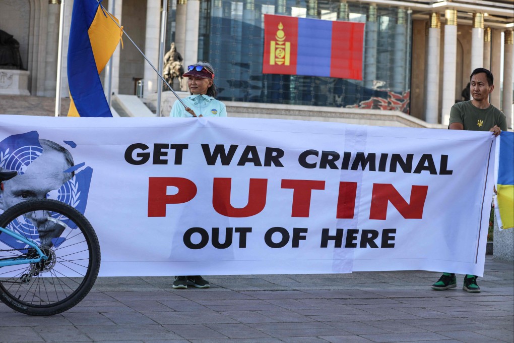 People holding Ukrainian national flags and a banner take part in a protest ahead of a visit by Russian President Vladimir Putin in Mongolia’s capital Ulaanbaatar on Monday. Photo: AFP