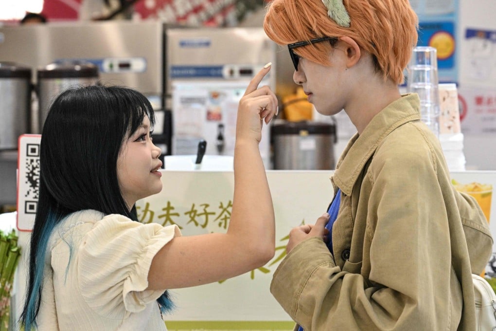 Cosplayer Xu Yunting (right), dressed as a male character from a video game, and client Feng Xinyu during a “cos commissioning” date in Shanghai. Photo: AFP