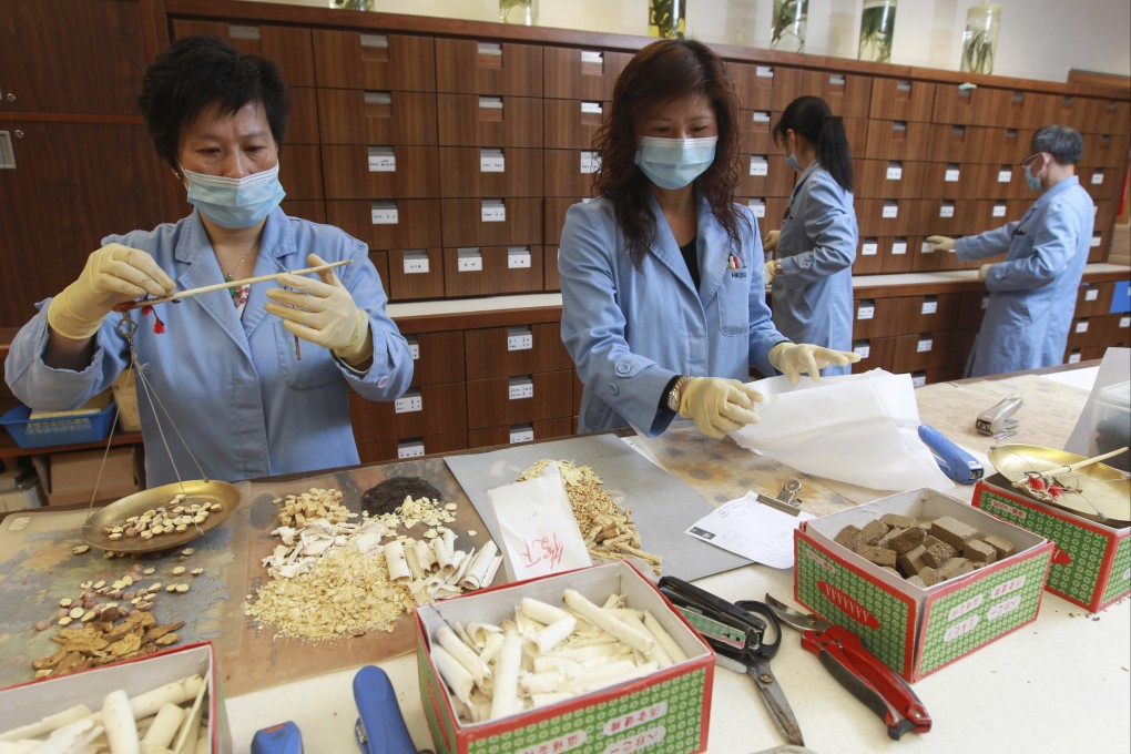 Students weigh out Chinese medicine ingredients at Hong Kong Baptist University, in December 2013. Photo: Dickson Lee