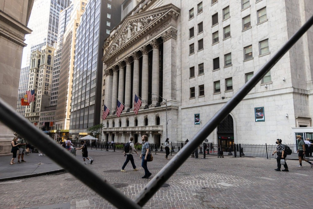 Pedestrians walk along Wall Street near the New York Stock Exchange on August 27.Talking about a Fed rate cut has been a psychological crutch for asset markets for two years. Photo: Bloomberg