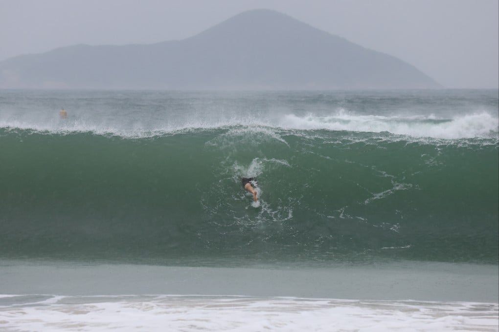 A surfer at Shek O ahead of a typhoon last year. When extreme weather warnings are up, steer clear of beaches. Photo: Dickson Lee