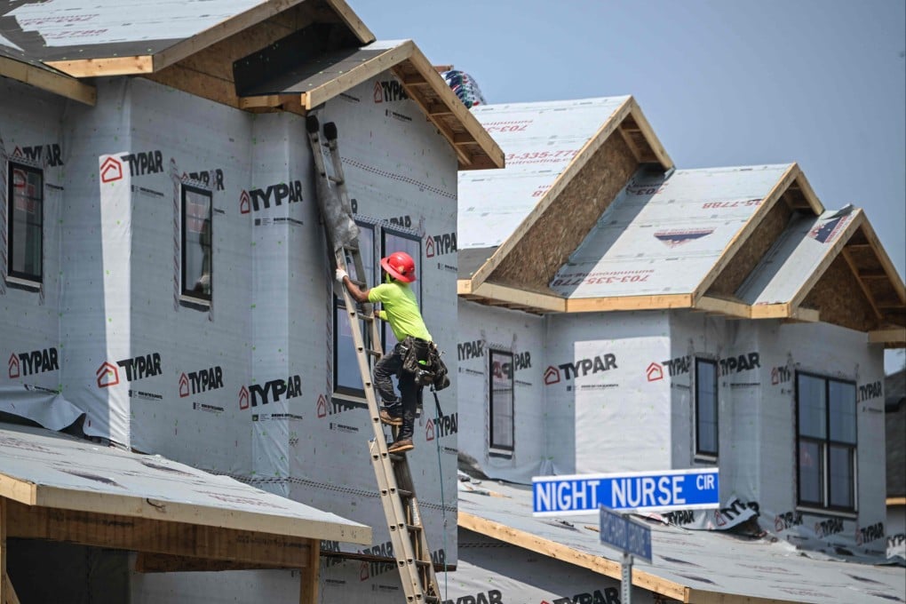 A construction worker climbs to the second story of a house under construction in a new development in Brambleton, Virginia, on August 14. US consumer inflation eased slightly in July, according to US Labour Department data, its smallest 12-month increase since March 2021 and a positive sign for the Federal Reserve as it weighs cutting interest rates. Photo: AFP