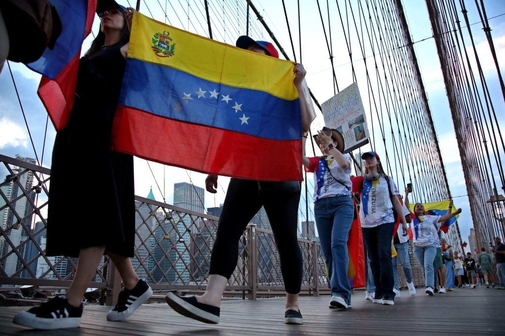 People hold Venezuelan flags as they protest against President Nicolas Maduro and the results of the recent election on the Brooklyn Bridge in New York in August. Photo: AFP